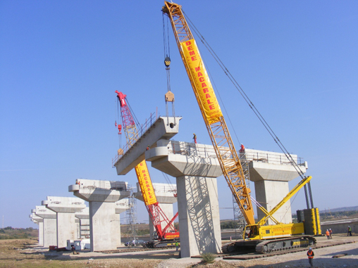 Two cranes constructing overpass